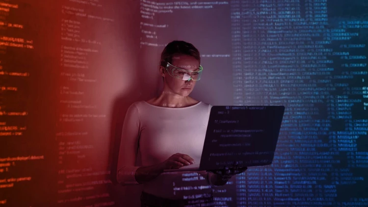 A professional using advanced data & ai technologies, visualizing strings of code and complex data flows projected onto a screen and the surrounding environment.