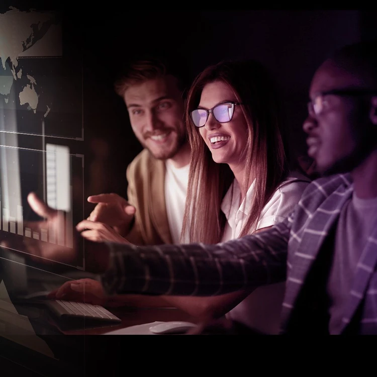 A team at work in front of a bright screen, trying to figure out the right strategy to match the technology.